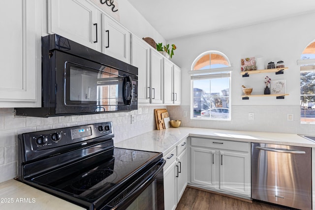 kitchen with tasteful backsplash, plenty of natural light, white cabinets, and black appliances