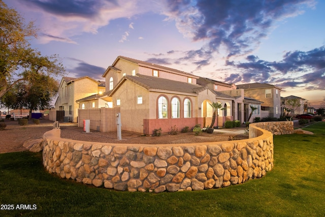 exterior space with stucco siding, a lawn, a tile roof, fence, and cooling unit