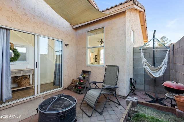 view of patio / terrace with fence and a fire pit