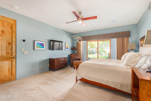 carpeted bedroom with ceiling fan and access to exterior