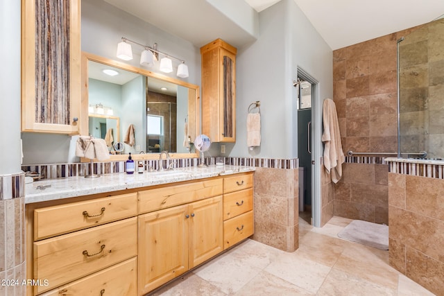 bathroom featuring tile flooring, tile walls, and vanity