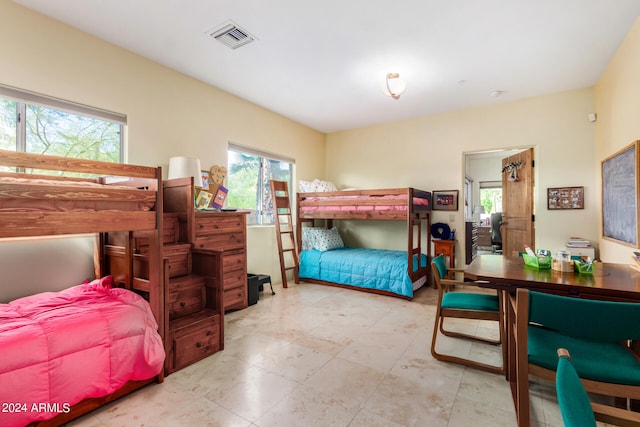 tiled bedroom featuring multiple windows