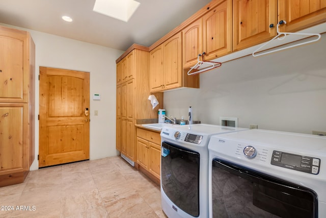 laundry room with cabinets, hookup for a washing machine, sink, washing machine and dryer, and light tile flooring