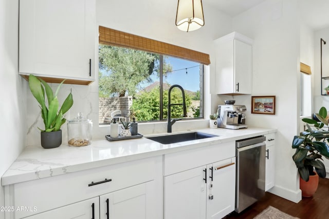 4525 N 66th St Unit 1, Scottsdale, AZ 85251 - kitchen with stainless steel dishwasher, white cabinets, dark wood-style floors, backsplash, and light stone counters