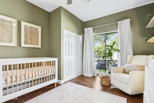 4525 N 66th St Unit 1, Scottsdale, AZ 85251 - bedroom with wood finished floors, a crib, a closet, and ceiling fan
