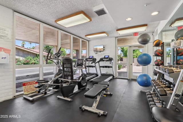 4525 N 66th St Unit 1, Scottsdale, AZ 85251 - gym featuring plenty of natural light, a textured ceiling, and floor to ceiling windows