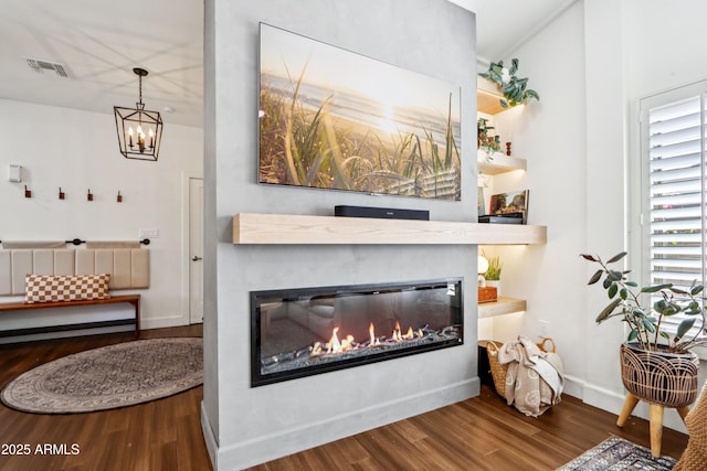 4525 N 66th St Unit 1, Scottsdale, AZ 85251 - living area with wood finished floors, a glass covered fireplace, and a chandelier