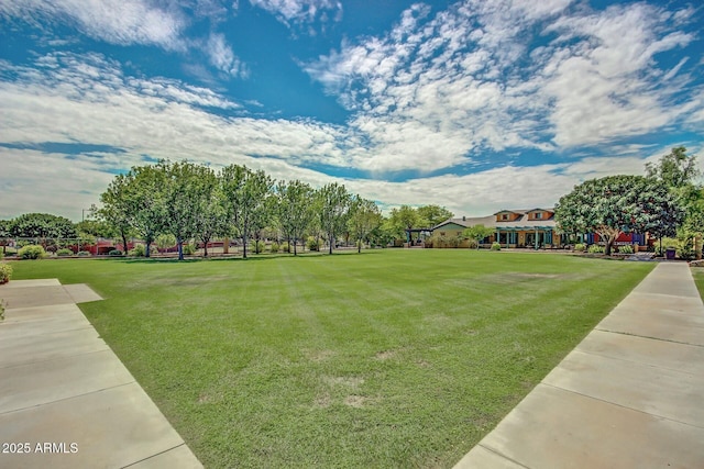 view of property's community with a lawn