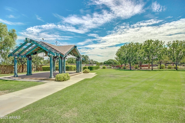 surrounding community featuring a patio, a lawn, and fence