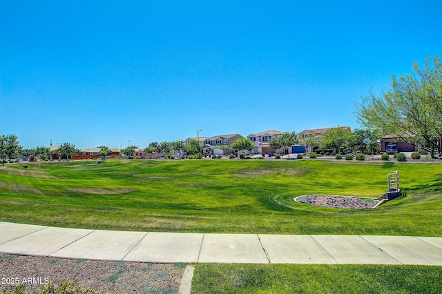 view of property's community with a yard and a residential view