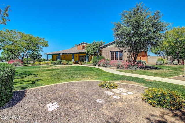 view of front of property featuring brick siding and a front lawn