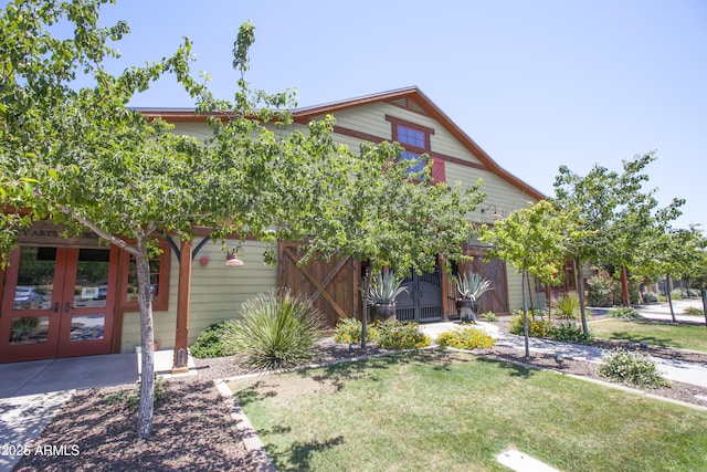 view of front of property featuring french doors and a front yard