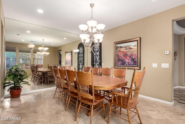 dining space with recessed lighting, baseboards, and an inviting chandelier