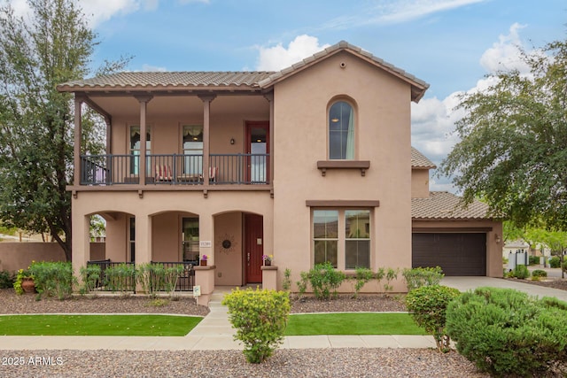 mediterranean / spanish home featuring stucco siding, concrete driveway, a garage, a balcony, and a tiled roof