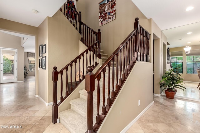 stairs with tile patterned floors, recessed lighting, and baseboards