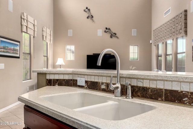 details with light countertops, visible vents, and a sink