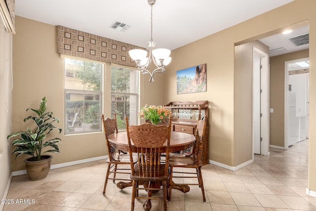 dining space with a chandelier, visible vents, and baseboards