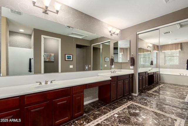 full bathroom featuring double vanity, visible vents, and a sink