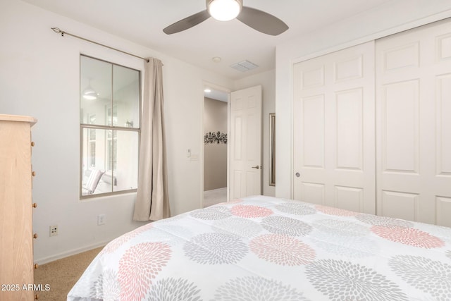 bedroom with a ceiling fan, visible vents, baseboards, a closet, and carpet flooring