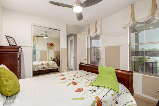 carpeted bedroom featuring a closet, visible vents, and ceiling fan