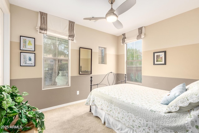 carpeted bedroom with baseboards and ceiling fan