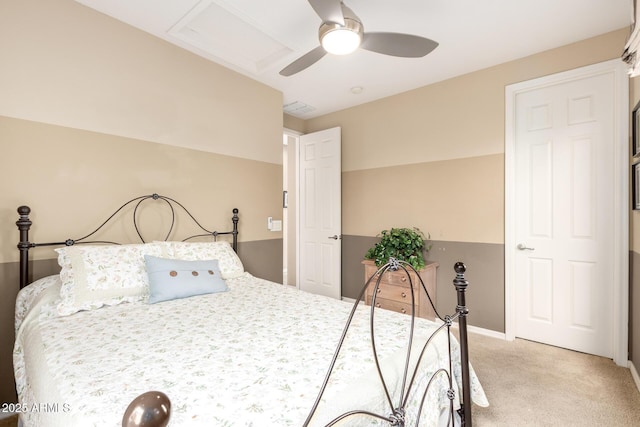 bedroom featuring baseboards, light colored carpet, visible vents, and ceiling fan