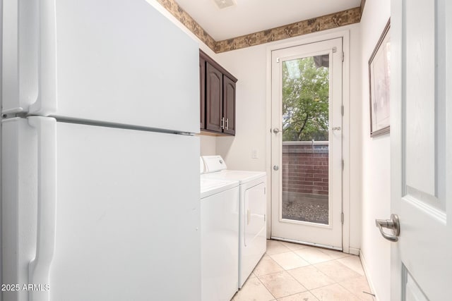 laundry room with washer and dryer, light tile patterned floors, cabinet space, and visible vents