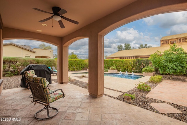 view of patio / terrace with ceiling fan, a fenced in pool, and grilling area