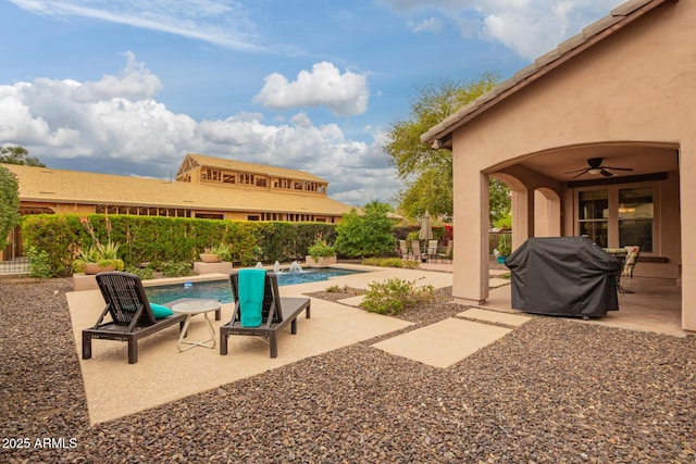 view of patio / terrace with grilling area, a fenced in pool, ceiling fan, and fence