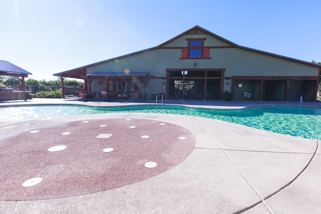 pool featuring fence and a patio area