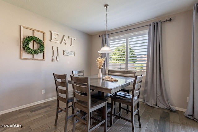 dining space with dark wood-type flooring