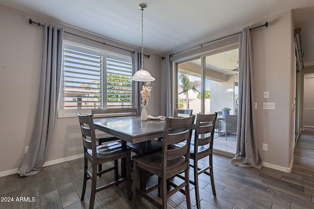 dining space with ceiling fan and dark hardwood / wood-style flooring