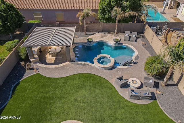 view of pool with a patio area, an in ground hot tub, and a lawn