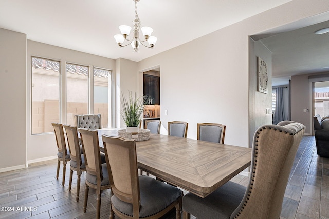 dining space with an inviting chandelier and dark hardwood / wood-style flooring