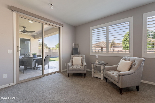 sitting room featuring ceiling fan and carpet flooring