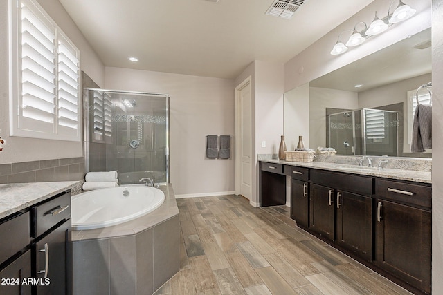 bathroom with vanity, separate shower and tub, and hardwood / wood-style flooring