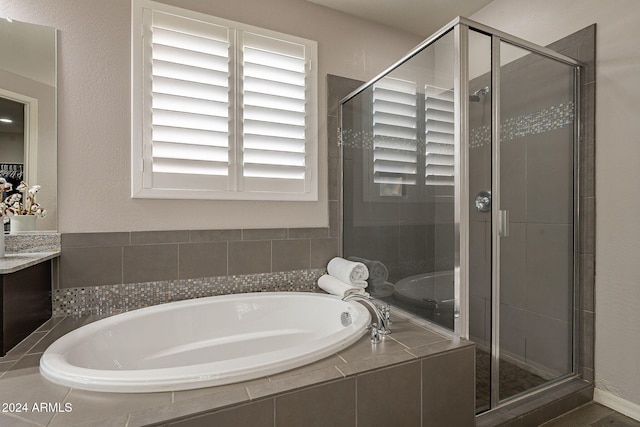 bathroom featuring vanity and plus walk in shower