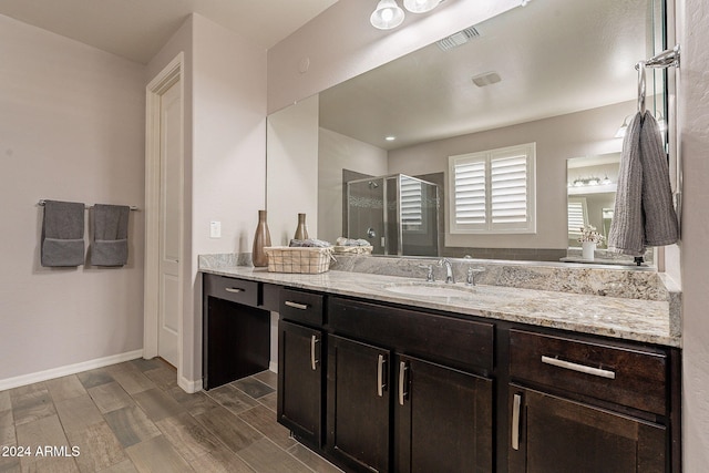 bathroom with vanity, hardwood / wood-style floors, and an enclosed shower