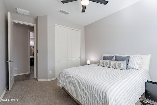 carpeted bedroom featuring a closet and ceiling fan