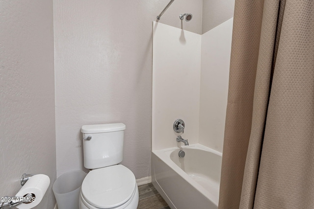 bathroom featuring bathtub / shower combination and toilet