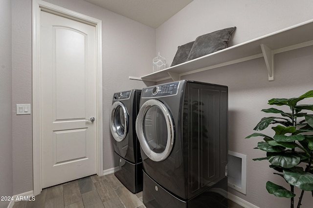 washroom featuring washer and clothes dryer and hardwood / wood-style floors