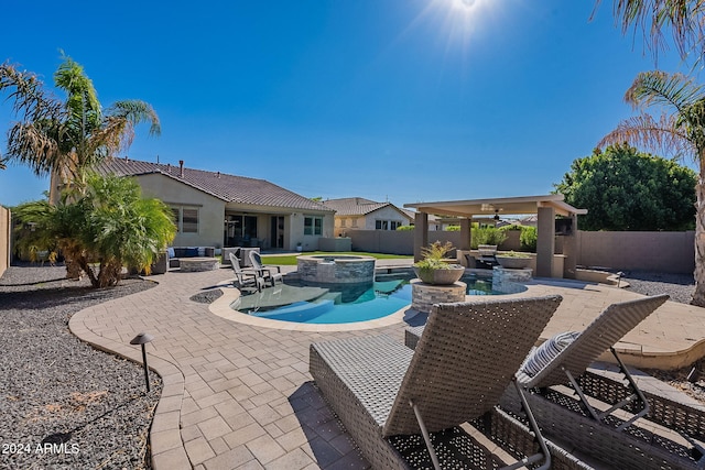 view of swimming pool with a patio area, an in ground hot tub, and ceiling fan