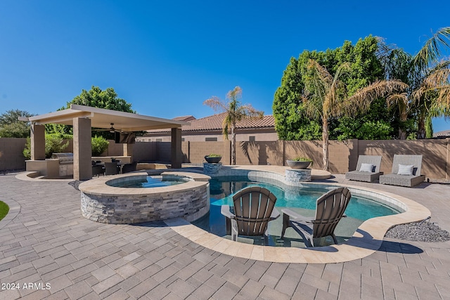 view of swimming pool featuring an in ground hot tub, a patio area, and ceiling fan