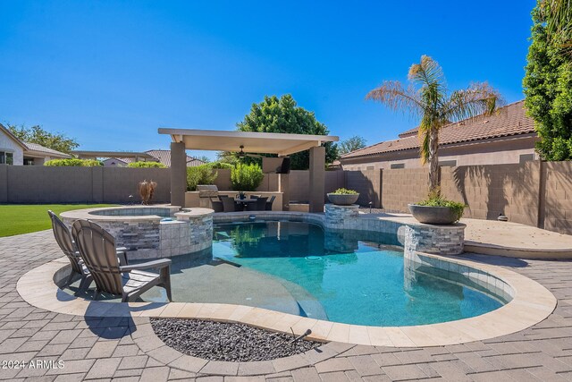 view of pool featuring a patio area and an in ground hot tub