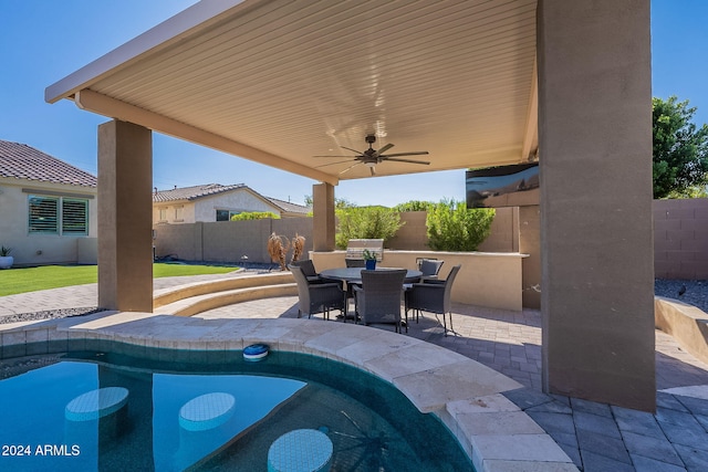 view of patio / terrace featuring a fenced in pool and ceiling fan