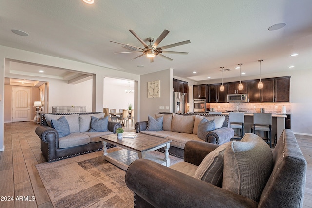 living room featuring ceiling fan and light hardwood / wood-style flooring