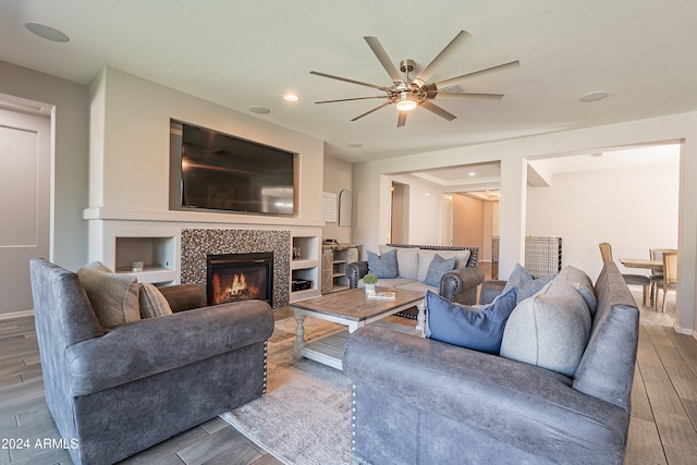 living room with hardwood / wood-style floors, a fireplace, and ceiling fan