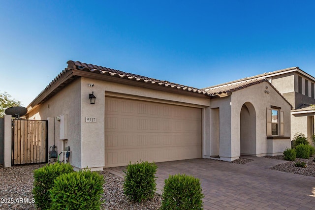 mediterranean / spanish home with a garage