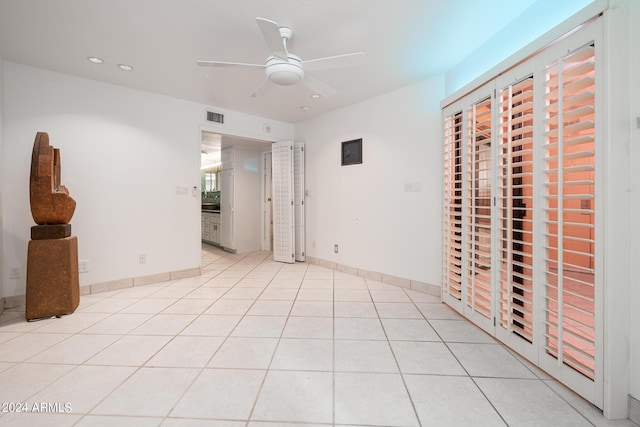 unfurnished bedroom featuring ceiling fan and light tile patterned flooring