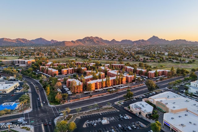 aerial view at dusk featuring a mountain view